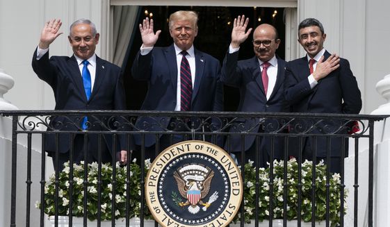 Israeli Prime Minister Benjamin Netanyahu, left, President Donald Trump, Bahrain Foreign Minister Khalid bin Ahmed Al Khalifa and United Arab Emirates Foreign Minister Abdullah bin Zayed al-Nahyan react on the Blue Room Balcony after signing the Abraham Accords during a ceremony on the South Lawn of the White House, Tuesday, Sept. 15, 2020, in Washington. (AP Photo/Alex Brandon)