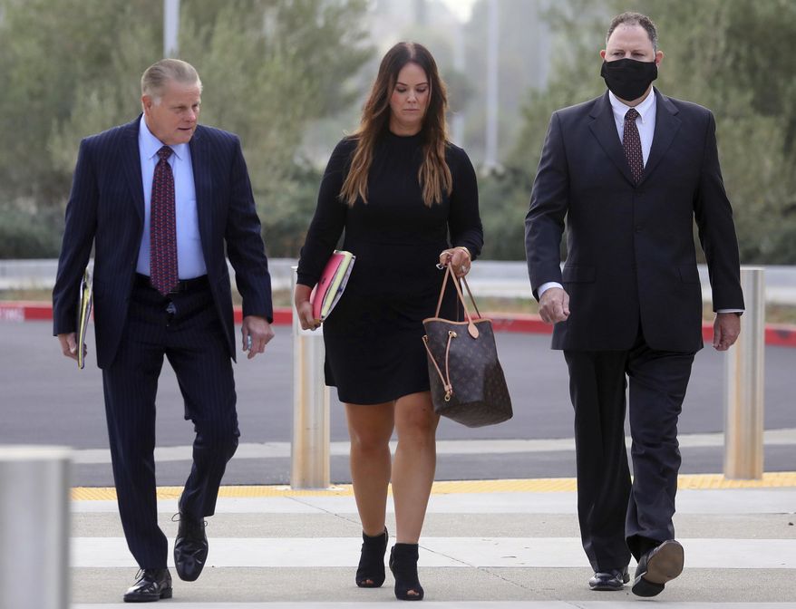 Attorneys Mike Rains, left, Julia Fox, center, and San Leandro Police Officer Jason Fletcher, right, arrive at the East County Hall of Justice on Tuesday, Sept. 15, 2020, in Dublin, Calif. A police officer facing manslaughter charges in the shooting death of a Black man inside a San Francisco Bay Area Walmart store was handcuffed and taken to jail following a court appearance Tuesday. Judge Barbara Dickinson denied a defense attorney request to allow San Leandro Police Officer Jason Fletcher to immediately post $200,000 bail, saying it was not the court&#39;s practice to allow that. (Aric Crabb/Bay Area News Group via AP)