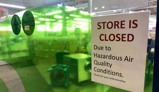 A sign at a Whole Foods in Lake Oswego, Ore., advises that the store is closed due to poor air quality Monday, Sept. 14, 2020. Another sign said all Whole Foods stores in the Portland Metro area will be closed at least through Thursday due to air quality. People across the West struggled under acrid-yellowish green smog from raging wildfires that seeped into homes and businesses, sneaked into cars through air conditioning vents and caused the temporary closure of iconic locations such as Powell&#39;s Books and the Oregon Zoo. (AP Photo/Gillian Flaccus) ** FILE **
