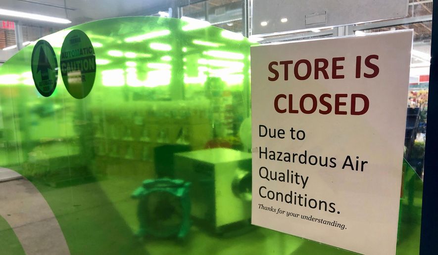 A sign at a Whole Foods in Lake Oswego, Ore., advises that the store is closed due to poor air quality Monday, Sept. 14, 2020. Another sign said all Whole Foods stores in the Portland Metro area will be closed at least through Thursday due to air quality. People across the West struggled under acrid-yellowish green smog from raging wildfires that seeped into homes and businesses, sneaked into cars through air conditioning vents and caused the temporary closure of iconic locations such as Powell&#x27;s Books and the Oregon Zoo. (AP Photo/Gillian Flaccus) ** FILE **