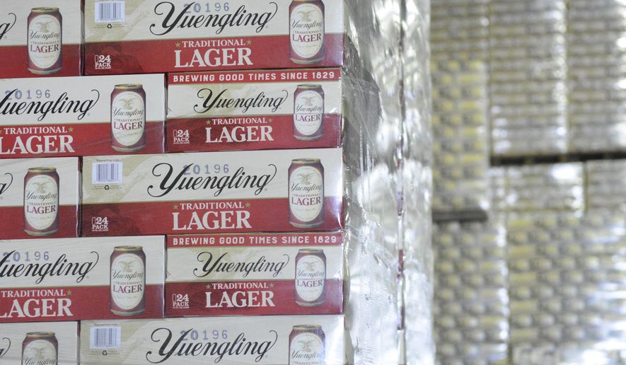 FILE - Cases of canned Yuengling Traditional Lager are stacked in the warehouse of the D.G. Yuengling & Son Brewery Mill Creek plant on Tuesday, July 21, 2020, in Pottsville, Pa. Pottsville, Pennsylvania-based D.G. Yuengling and Son Inc. said Tuesday, Sept. it’s forming a joint venture with Molson Coors Beverage Co. to expand distribution of its beers beyond the East Coast. Yuengling, a 191-year-old family-owned brewery known for its cheap German-style lager, will remain independent.(Lindsey Shuey/Republican-Herald via AP, File)