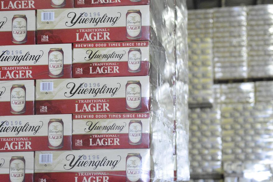 FILE - Cases of canned Yuengling Traditional Lager are stacked in the warehouse of the D.G. Yuengling & Son Brewery Mill Creek plant on Tuesday, July 21, 2020, in Pottsville, Pa. Pottsville, Pennsylvania-based D.G. Yuengling and Son Inc. said Tuesday, Sept. it’s forming a joint venture with Molson Coors Beverage Co. to expand distribution of its beers beyond the East Coast. Yuengling, a 191-year-old family-owned brewery known for its cheap German-style lager, will remain independent.(Lindsey Shuey/Republican-Herald via AP, File)