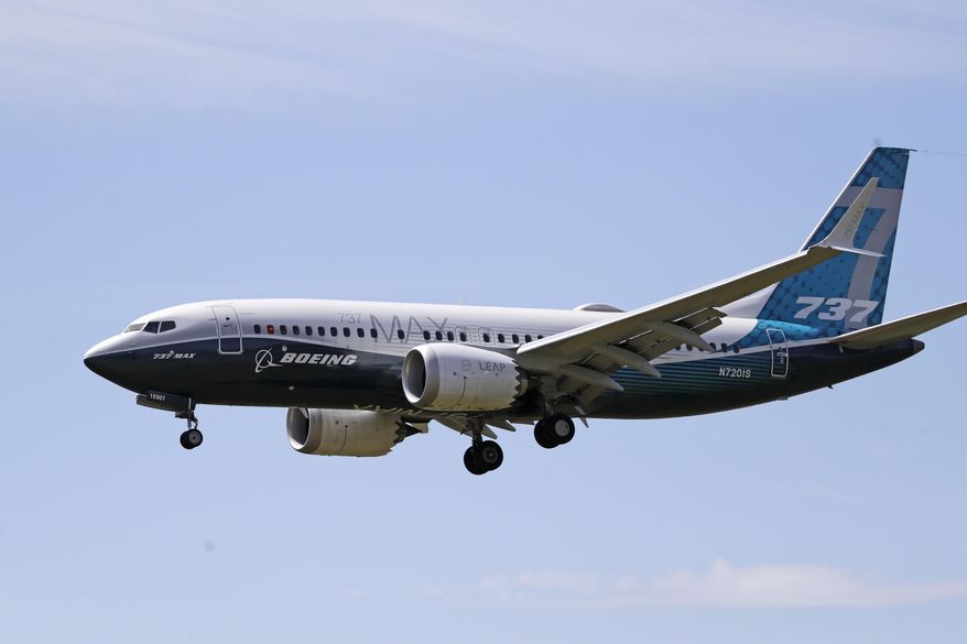 FILE - In this Monday, June 29, 2020, file photo, a Boeing 737 Max jet heads to a landing at Boeing Field following a test flight in Seattle. A U.S. House committee is questioning whether Boeing and the Federal Aviation Administration have recognized problems that caused two deadly 737 Max jet crashes and if either organization will be willing to make significant changes to fix them. (AP Photo/Elaine Thompson, File)