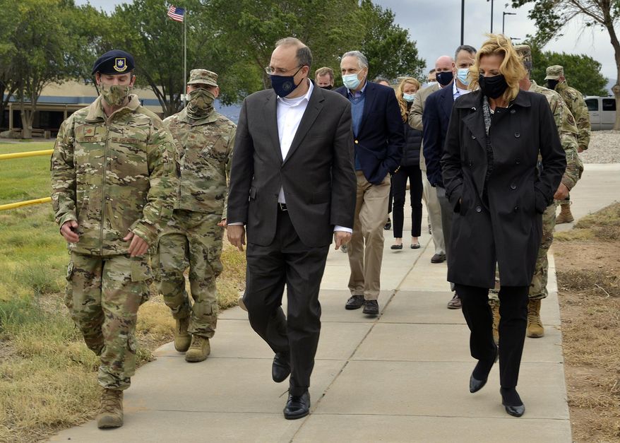In this Sept. 9, 2020, image provided by the U.S. Air Force, is Marshall Billingslea, special presidential envoy for arms control, center, and National Nuclear Security Administration Administrator Lisa Gordon-Hagerty, right, walking with Air Force personnel between meetings at Kirtland Air Force Base in Albuquerque, N.M.  The Trump administration has sketched out a framework that it hopes will avoid a three-way arms race as a deadline nears for extending the only remaining nuclear arms control deal with Russia and as China looks to expand its nuclear forces.  (Todd R. Berenger/U.S. Air Force, via AP)