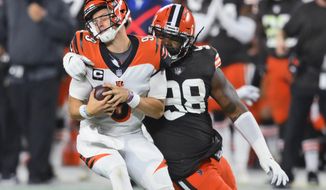 Cleveland Browns defensive tackle Sheldon Richardson (98) sacks Cincinnati Bengals quarterback Joe Burrow (9) during the first half of an NFL football game Thursday, Sept. 17, 2020, in Cleveland. (AP Photo/David Richard)