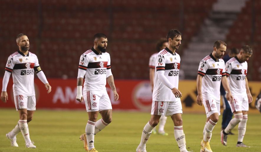 Brazil's Flamengo players leave the field at half-time during their Copa Libertadores soccer match against Ecuador's Independiente del Valle in Quito, Ecuador, Thursday, Aug. 17, 2020. (Jose Jacome/Pool via AP)