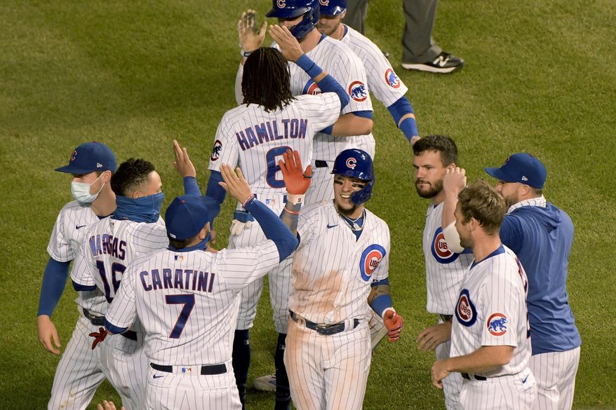 Chicago Cubs&#39; Javier Baez (9) celebrates with teammates after driving in the winning run during the 10th inning against the Cleveland Indians in a baseball game Wednesday, Sept. 16, 2020, in Chicago. (AP Photo/Mark Black)