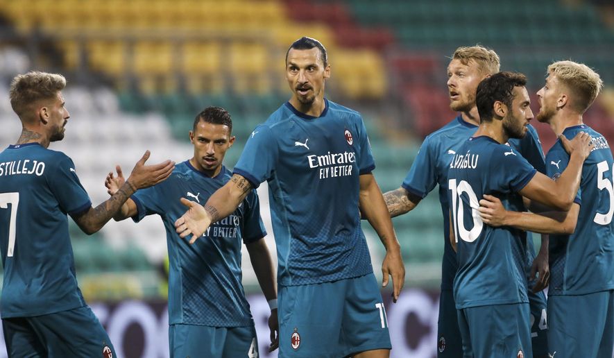 AC Milan's Zlatan Ibrahimovic, center, celebrates with his teammates after he scored his side's first goal during an Europa League second qualifying round soccer match between Shamrock Rovers and AC Milan at the Tallaght Stadium in Dublin, Thursday, Sept. 17, 2020. (AP Photo/Peter Morgan)