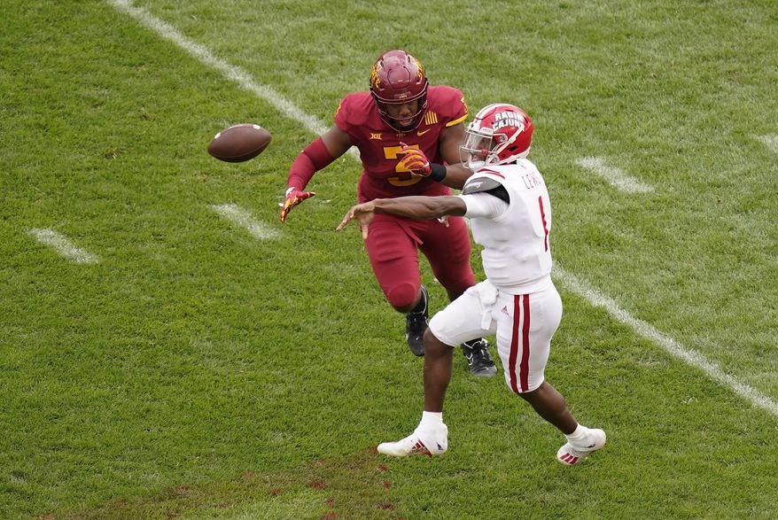 Louisiana-Lafayette quarterback Levi Lewis passes while getting pressure from Iowa State defensive end JaQuan Bailey, left, during the first half of an NCAA college football game, Saturday, Sept. 12, 2020, in Ames, Iowa. (AP Photo/Charlie Neibergall)
