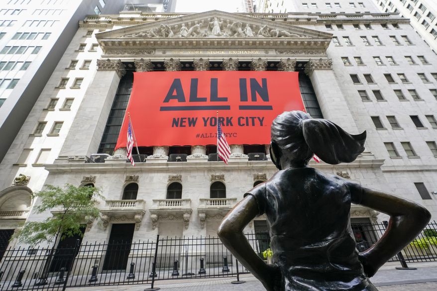 FILE - The "Fearless Girl" bronze sculpture looks towards the New York Stock Exchange, Thursday, Sept. 10, 2020, in New York. Most everyone along Wall Street agrees that stocks are expensive following their amazing return to records despite the still-raging pandemic. Where they disagree is whether that’s something to worry about. (AP Photo/Mary Altaffer)