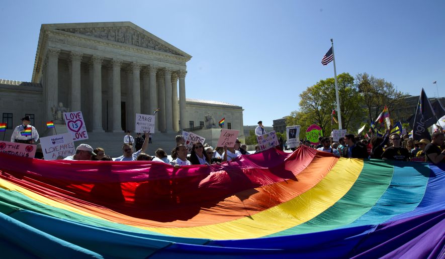 FILE - In this April 28, 2015 file photo, demonstrators stand in front of a rainbow flag of the Supreme Court in Washington. In 2019, there were slightly less than 1 million same-sex couple households in the U.S., and a majority of those couples were married. New figures released Thursday, Sept. 17, 2020 by the U.S. Census Bureau shows that of the 980,000 same-sex couple households, 58% were married couples and 42% were unmarried partners. (AP Photo/Jose Luis Magana, File)