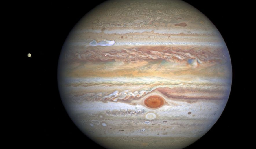 This Aug 25, 2020 image captured by NASA&#39;s Hubble Space Telescope shows the planet Jupiter and one of its moons, Europa, at left, when the planet was 406 million miles from Earth. The new photo was released by the Space Telescope Science Institute in Baltimore on Thursday, Sept. 17, 2020. (NASA, ESA, STScI, A. Simon, M. via AP)