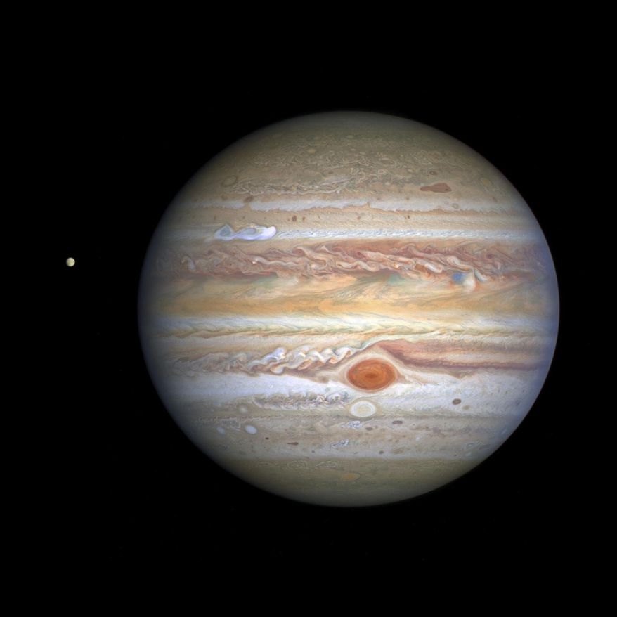 This Aug 25, 2020 image captured by NASA's Hubble Space Telescope shows the planet Jupiter and one of its moons, Europa, at left, when the planet was 406 million miles from Earth. The new photo was released by the Space Telescope Science Institute in Baltimore on Thursday, Sept. 17, 2020. (NASA, ESA, STScI, A. Simon, M. via AP)