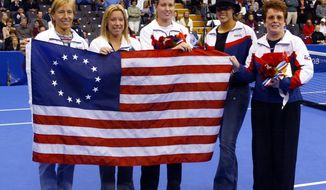 FILE - In this file photo dated Thursday, Oct. 30, 2003, U.S. Fed Cup members from left, Martina Navrartilova, Lisa Raymond, Meghann Shaughnessy, Alexandra Stevenson and Fed Cup Captain Billie Jean King, accept a replica of the Betsy Ross Flag at the Advanta Championships, in VIllanova, USA.  The Fed Cup is changing its name to honour tennis great Billie Jean King, becoming The Billie Jean King Cup, the first major global team competition to be named after a woman, it is announced Thursday Sept. 17, 2020.(AP Photo/Miles Kennedy, FILE)