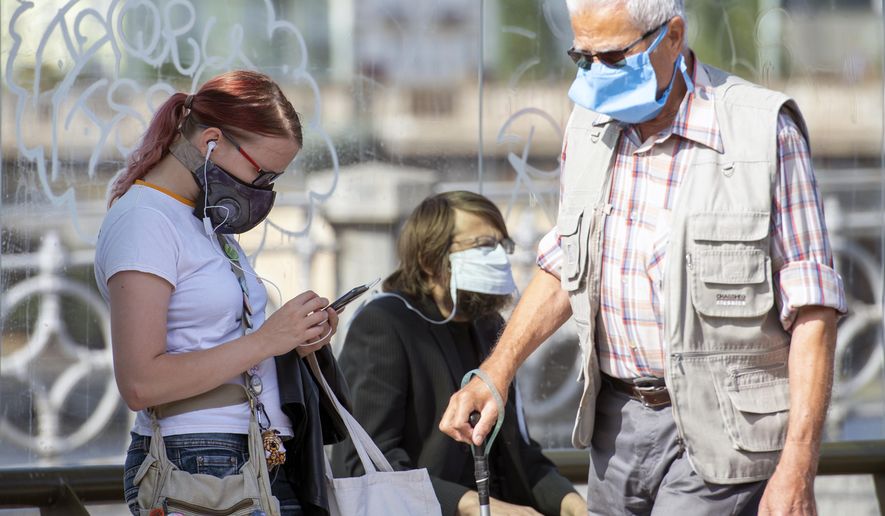 People wearing face masks as they wait at a train station in Prague, Czech Republic, Thursday, Sept. 17, 2020 The number of new confirmed coronavirus infections have hit a record in the Czech Republic, surpassing 2,000 cases in one day for the first time. (Sulova Katerina/CTKvia AP)