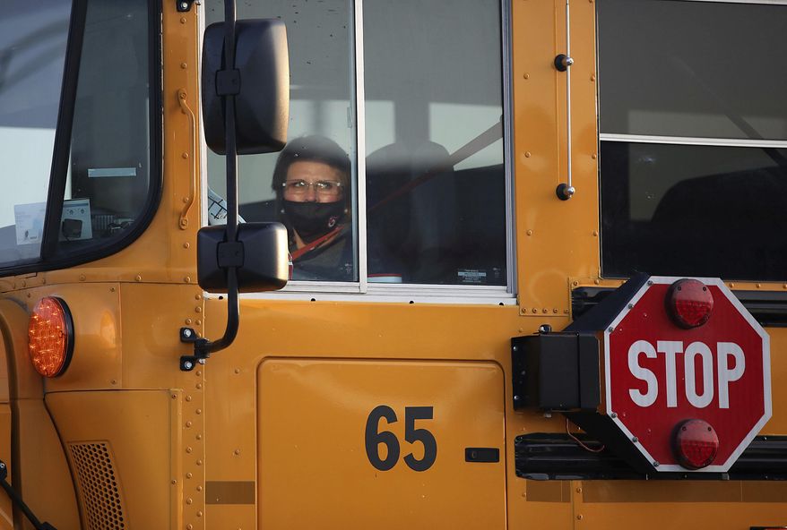 A bus driver travels her route on the first day of in-person instruction at Owasso schools Thursday, Sept. 17, 2020 in Owasso, Okla. (Mike Simons/Tulsa World via AP)