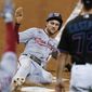Washington Nationals&#39; Trea Turner slides into home to score on a sacrifice fly by Kurt Suzuki during the first inning of the second game of the team&#39;s baseball doubleheader against the Miami Marlins, Friday, Sept. 18, 2020, in Miami. (AP Photo/Wilfredo Lee)