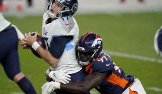 Tennessee Titans quarterback Ryan Tannehill (17) is sacked by Denver Broncos linebacker Jeremiah Attaochu (97) during the first half of an NFL football game, Monday, Sept. 14, 2020, in Denver. (AP Photo/David Zalubowski)