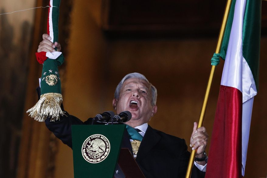 Mexican President Andres Manuel Lopez Obrador rings the bell as he gives the annual independence shout from the balcony of the National Palace to kick off subdued Independence Day celebrations amid the ongoing coronavirus pandemic, at the Zocalo in Mexico City, Tuesday, Sept. 15, 2020. Instead of the throngs of supporters who pack the Zocalo in a typical year, this Independence Day the president faced an empty plaza as he gave the traditional &amp;quot;Grito de Dolores,&amp;quot; which commemorates the 1810 call to arms by priest Miguel Hidalgo that began the struggle for independence from Spain. (AP Photo/Rebecca Blackwell)