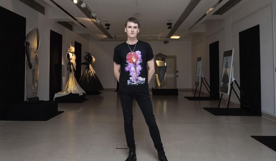Fashion designer Gareth Pugh poses for a photograph in front of his creations, exhibited ahead of his London Fashion Week show in London, Wednesday, Sept. 16, 2020. (Photo by Vianney Le Caer/Invision/AP)