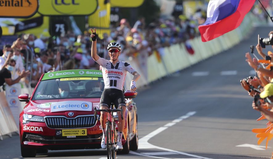 Denmark's Soren Kragh Andersen celebrates as he crosses the line to win the 19th stage of the Tour de France cycling race over 166.5 kilometers between Bourg-En-Bresse and Champagole, France Friday, Sept. 3, 2020. (Marco Bertorello/Pool via AP)
