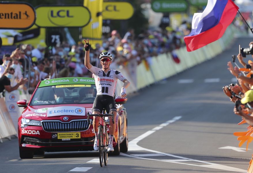 Denmark's Soren Kragh Andersen celebrates as he crosses the line to win the 19th stage of the Tour de France cycling race over 166.5 kilometers between Bourg-En-Bresse and Champagole, France Friday, Sept. 3, 2020. (Marco Bertorello/Pool via AP)