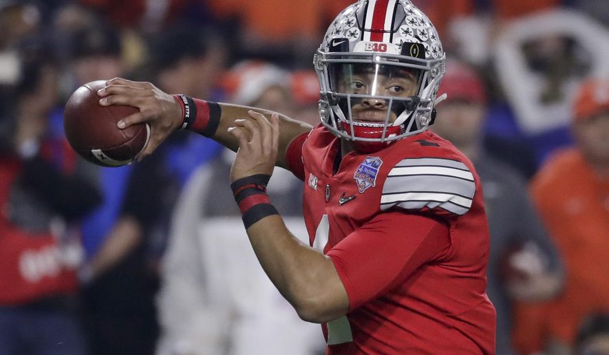 FILE - In this Dec. 28, 2019, file photo, Ohio State quarterback Justin Fields throws a pass against Clemson during the first half of the Fiesta Bowl NCAA college football playoff semifinal in Glendale, Ariz. When Fields got together with some of his teammates last Saturday to watch college football on TV, the mood was dark. “Distraught,” Fields said. (AP Photo/Rick Scuteri, File)