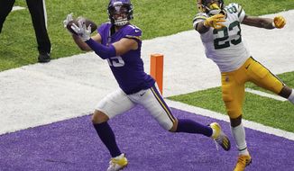 Minnesota Vikings wide receiver Adam Thielen (19) hauled in a touchdown pass as Green Bay Packers cornerback Jaire Alexander (23) tries to defend in the second half of an NFL football game Sunday, Sept. 13, 2020, in Minneapolis, Minn.  (Anthony Souffle/Star Tribune via AP)
