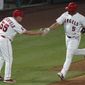 Los Angeles Angels&#39; Albert Pujols, right, is greeted by third base coach Brian Butterfield as he runs the bases on a solo home run during the fifth inning of the team&#39;s baseball game against the Texas Rangers on Friday, Sept. 18, 2020, in Anaheim, Calif. (AP Photo/Ashley Landis)