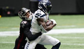 Atlanta Falcons cornerback Isaiah Oliver (26) tackles Seattle Seahawks wide receiver DK Metcalf (14) during the first half of an NFL football game, Sunday, Sept. 13, 2020, in Atlanta. (AP Photo/Brynn Anderson)