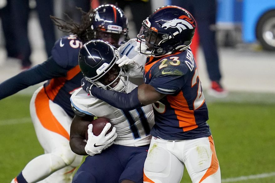 Tennessee Titans wide receiver A.J. Brown (11) is hit by Denver Broncos cornerback Michael Ojemudia (23) during the second half of an NFL football game, Monday, Sept. 14, 2020, in Denver. (AP Photo/David Zalubowski)