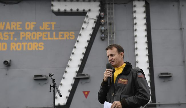 In this Nov. 15, 2019, file photo U.S. Navy Capt. Brett Crozier, then commanding officer of the aircraft carrier USS Theodore Roosevelt (CVN 71), addresses the crew during an all-hands call on the ship&#x27;s flight deck while conducting routine operations in the Eastern Pacific Ocean.  (Mass Communication Specialist 3rd Class Nicholas Huynh/U.S Navy via AP, File)