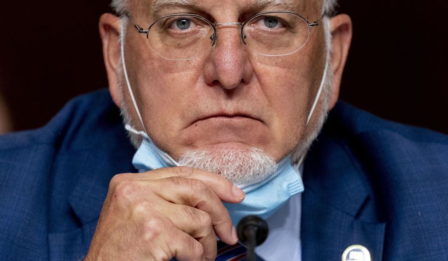 FILE - In this Wednesday, Sept. 16, 2020 file photo, the Centers for Disease Control and Prevention Director Dr. Robert Redfield pauses while speaking at a Senate Appropriations subcommittee hearing on a "Review of Coronavirus Response Efforts" on Capitol Hill in Washington. On Friday, Sept. 18, 2020, the CDC dropped a controversial piece of coronavirus guidance and said anyone who has been in close contact with an infected person should get tested. The CDC essentially returned to its previous testing guidance, getting rid of language posted last month that said people who didn't feel sick didn't need to get tested. (AP Photo/Andrew Harnik, Pool)
