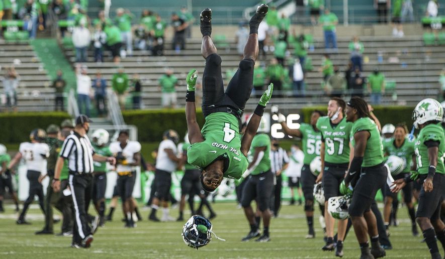 Marshall's Lawrence Papillon (4) does a backflip as Marshall players celebrate a win over No. 23 ranked Appalachian State after an NCAA college football game Saturday, Sept. 19, 2020, in Huntington, W.Va. (Sholten Singer/The Herald-Dispatch via AP)