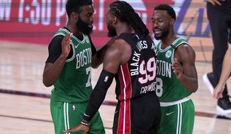 Boston Celtics&#39; Jaylen Brown, left, and Miami Heat&#39;s Jae Crowder (99) exchange words as Kemba Walker (8) attempts to calm the situation during the second half of an NBA conference final playoff basketball game, Saturday, Sept. 19, 2020, in Lake Buena Vista, Fla. (AP Photo/Mark J. Terrill)