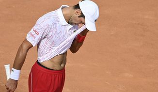 Serbia&#39;s Novak Djokovic wipes his face during his match with Germany&#39;s Dominik Koepfer during their quarterfinals at the Italian Open tennis tournament, in Rome, Saturday, Sept. 19, 2020. (Alfredo Falcone/LaPresse via AP)