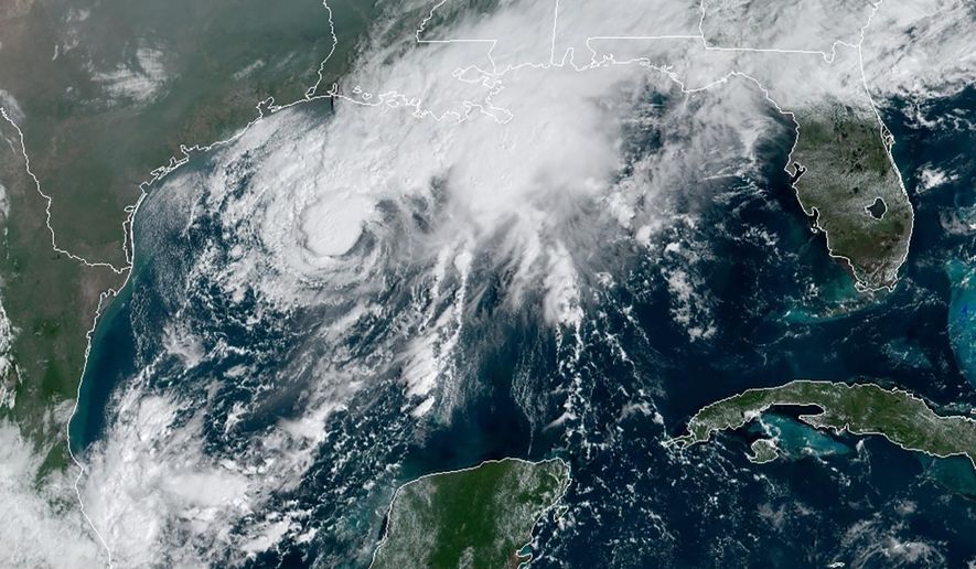 This GOES-16 GeoColor satellite image taken Saturday, Sept. 19, 2020, and provided by NOAA, shows Tropical Storm Beta, center,  in the Gulf of Mexico.  A hurricane watch is in effect Saturday for coastal Texas as Tropical Storm Beta gains strength.  A storm surge watch and a tropical storm watch are also in effect for the area during an exceptionally busy Atlantic hurricane season.  (NOAA via AP)
