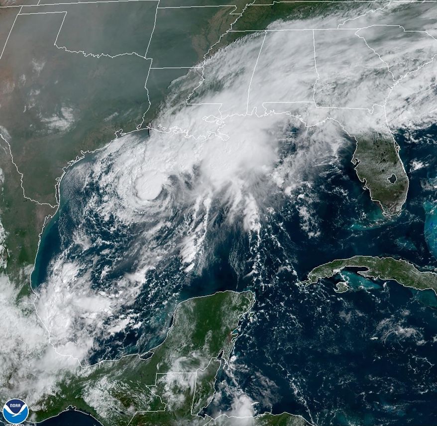 This GOES-16 GeoColor satellite image taken Saturday, Sept. 19, 2020, and provided by NOAA, shows Tropical Storm Beta, center,  in the Gulf of Mexico.  A hurricane watch is in effect Saturday for coastal Texas as Tropical Storm Beta gains strength.  A storm surge watch and a tropical storm watch are also in effect for the area during an exceptionally busy Atlantic hurricane season.  (NOAA via AP)
