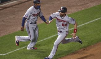 Minnesota Twins&#39; Jake Cave (60) runs to score on a single hit by Eddie Rosario against the Chicago Cubs during the sixth inning of a baseball game, Saturday, Sept. 19, 2020, in Chicago. (AP Photo/Kamil Krzaczynski)