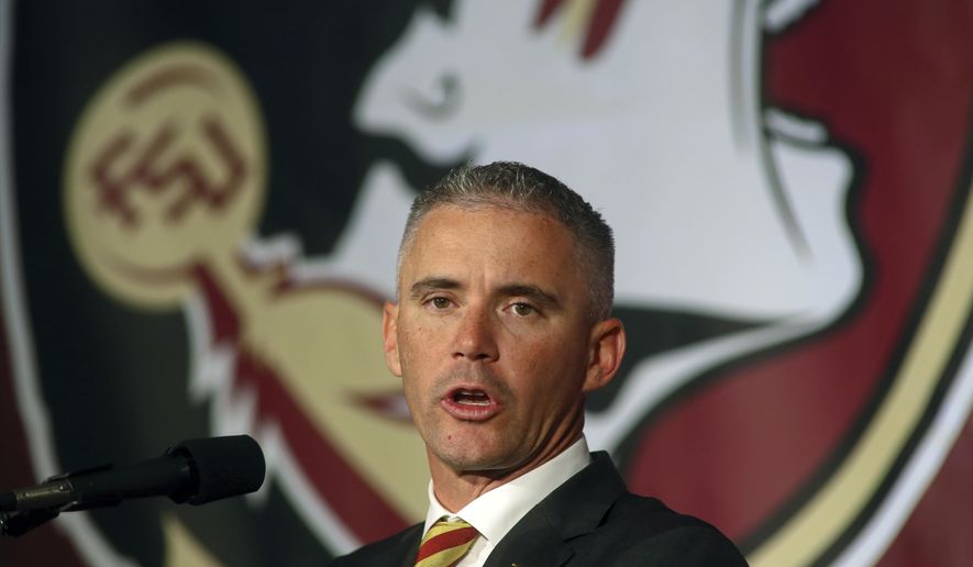 FILE - In this Dec. 8, 2019, file photo, Florida State head football coach Mike Norvell speaks at n during an NCAA college football press conference in Tallahassee, Fla. Norvell has tested positive for COVID-19 and will not coach the Seminoles in-person this week as they prepare for Miami. He released a statement Saturday, Sept. 19, 2020 saying he tested positive Friday. His wife and daughter tested negative Saturday morning, he said. (AP Photo/Phil Sears,  File)