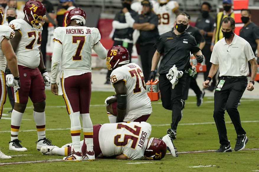 Washington Football Team offensive guard Brandon Scherff (75) lies on the turf after an injury against the Arizona Cardinals during the first half of an NFL football game, Sunday, Sept. 20, 2020, in Glendale, Ariz.(AP Photo/Ross D. Franklin) **FILE**
