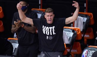 Miami Heat&#39;s Meyers Leonard (0) cheers on the team from the sideline during the second half of an NBA conference final playoff basketball game against the Boston Celtics on Saturday, Sept. 19, 2020, in Lake Buena Vista, Fla. (AP Photo/Mark J. Terrill)