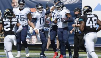 Tennessee Titans quarterback Ryan Tannehill (17) congratulates tight end Jonnu Smith (81) after the two teamed up for a 13-yard touchdown pass against the Jacksonville Jaguars in the first half of an NFL football game Sunday, Sept. 20, 2020, in Nashville, Tenn. (AP Photo/Mark Zaleski)