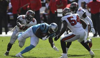 Carolina Panthers running back Mike Davis (28) splits between Tampa Bay Buccaneers linebacker Devin White (45) and outside linebacker Lavonte David (54) during the second half of an NFL football game Sunday, Sept. 20, 2020, in Tampa, Fla. (AP Photo/Jason Behnken)