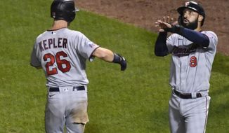 Minnesota Twins&#39; Max Kepler (26) celebrates with Minnesota Twins&#39; Marwin Gonzalez (9) after they score on Kepler&#39;s two-run home run during the seventh inning of a baseball game against the Chicago Cubs Sunday, Sept. 20, 2020, in Chicago. (AP Photo/Matt Marton)