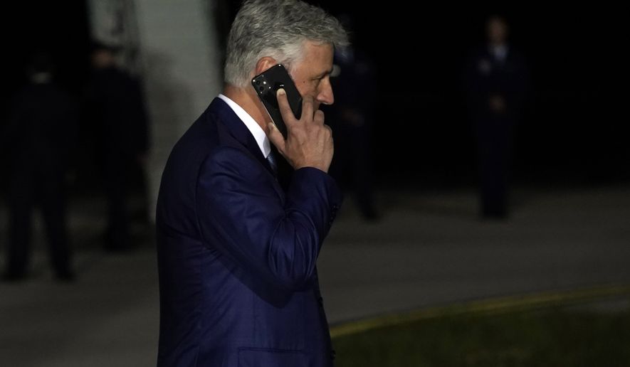 National Security Adviser Robert O&#39;Brien talks on the phone as President Donald Trump speaks during a campaign rally at Eugene F. Kranz Toledo Express Airport, Monday, Sept. 21, 2020, in Swanton, Ohio. (AP Photo/Alex Brandon)
