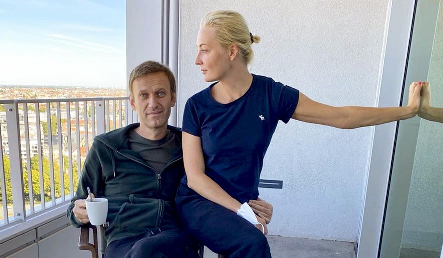 In this photo published by Russian opposition leader Alexei Navalny on his Instagram account on Monday, Sept. 21, 2020, Russian opposition leader Alexei Navalny and his wife Yulia pose for a photo in a hospital in Berlin. Navalny on Monday demanded that Russia returned clothes he was wearing on the day he fell into a coma, calling it a “crucial piece of evidence” of a suspected nerve agent poisoning he is being treated for at the German hospital. (Navalny Instagram via AP)