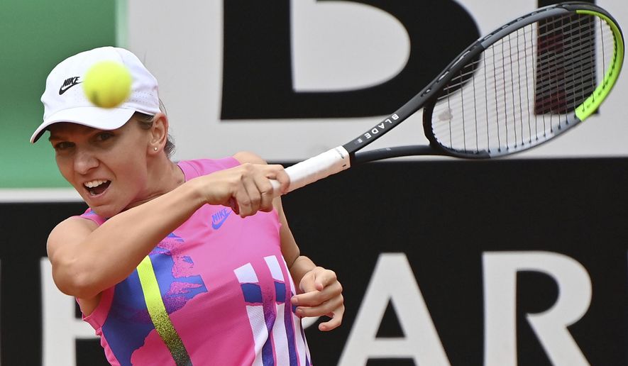 Romania's Simona Halep returns the ball to Czech Republic's Karolina Pliskova during their final match at the Italian Open tennis tournament, in Rome, Monday, Sept. 21, 2020. (Alfredo Falcone/LaPresse via AP)