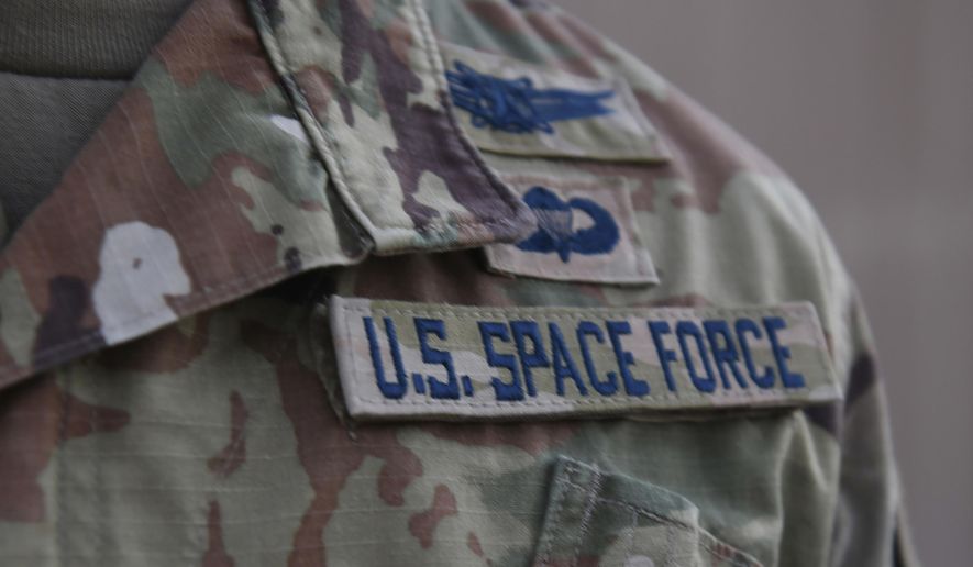 In this photo released by the U.S. Air Force, Capt. Ryan Vickers stands for a photo to display his new service tapes after taking his oath of office to transfer from the U.S. Air Force to the U.S. Space Force at Al-Udeid Air Base, Qatar, Tuesday, Sept. 1, 2020. Space Force, the first new U.S. military service since the creation of the Air Force in 1947, now has some 20 members stationed at Qatar&#39;s Al-Udeid Air Base in its first foreign deployment. (Staff Sgt. Kayla White/U.S. Air Force via AP) ** FILE **