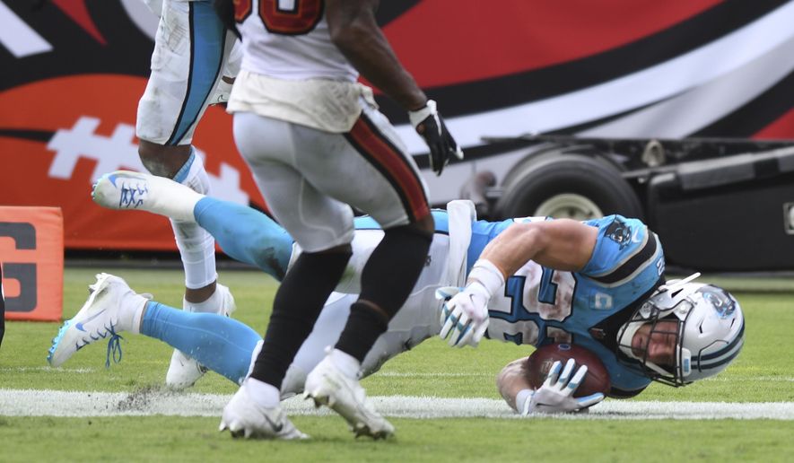 Carolina Panthers running back Christian McCaffrey (22) scores against the Tampa Bay Buccaneers during the second half of an NFL football game Sunday, Sept. 20, 2020, in Tampa, Fla. (AP Photo/Jason Behnken)